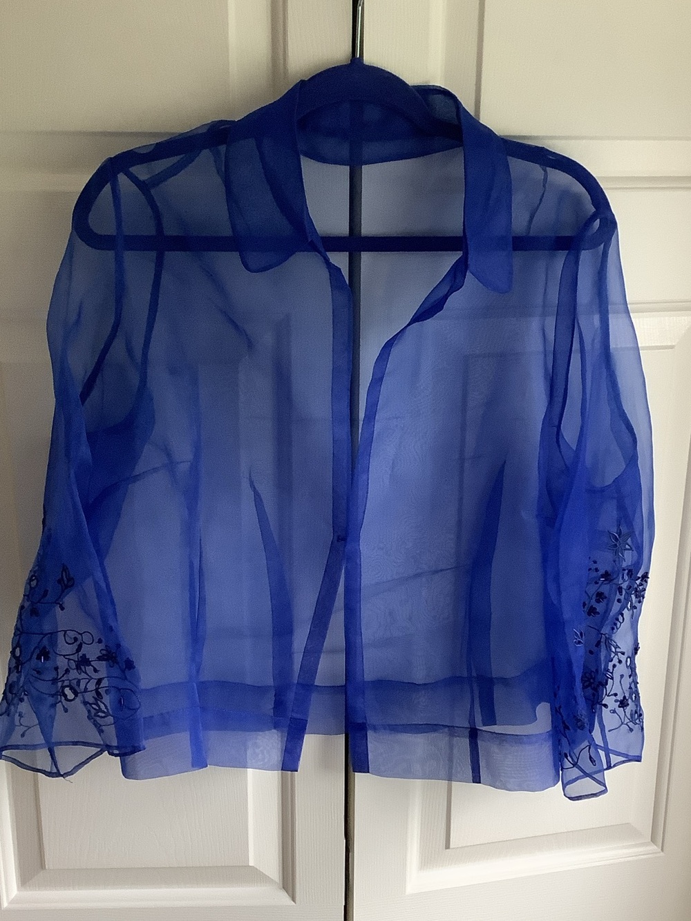 Organza/ mesh sheer evening coverup jacket with intricate sleeve embroidery.